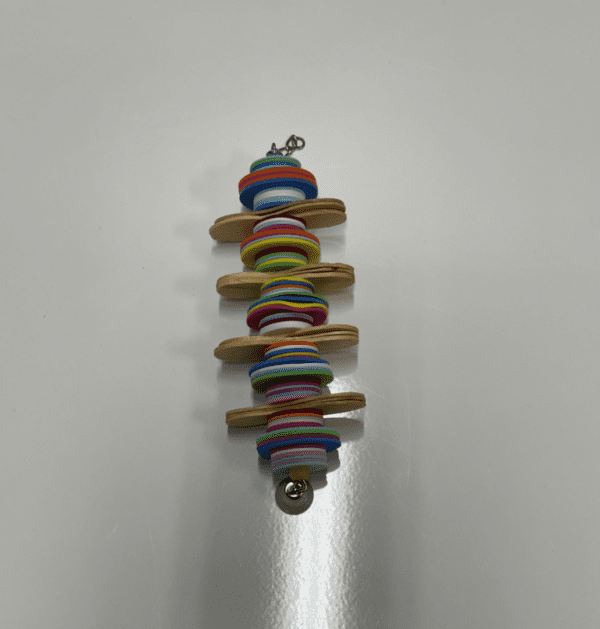 A wooden Spoon Fed toy with colorful buttons on it.